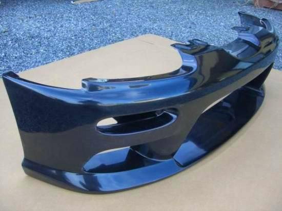 Toyoshima Craft original front bumper for a Cappuccino shown alone on a cardboard surface.