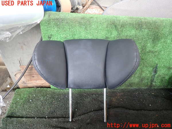 Used left second-row headrest for Alphard (AGH30W), black, shown front-facing with metal mounting posts on a green mat.