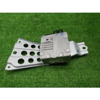 Toyota power steering computer unit 89650-68050 with attached mounting bracket shown on a green background.