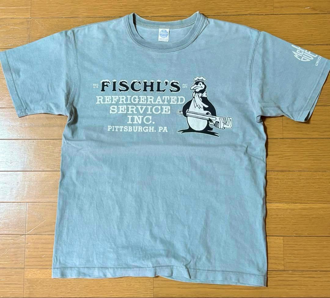 Flat-laid T-shirt showing the front graphic reading "FISCHL'S Refrigerated Service Inc. PITTSBURGH, PA" and a penguin holding a wrench.