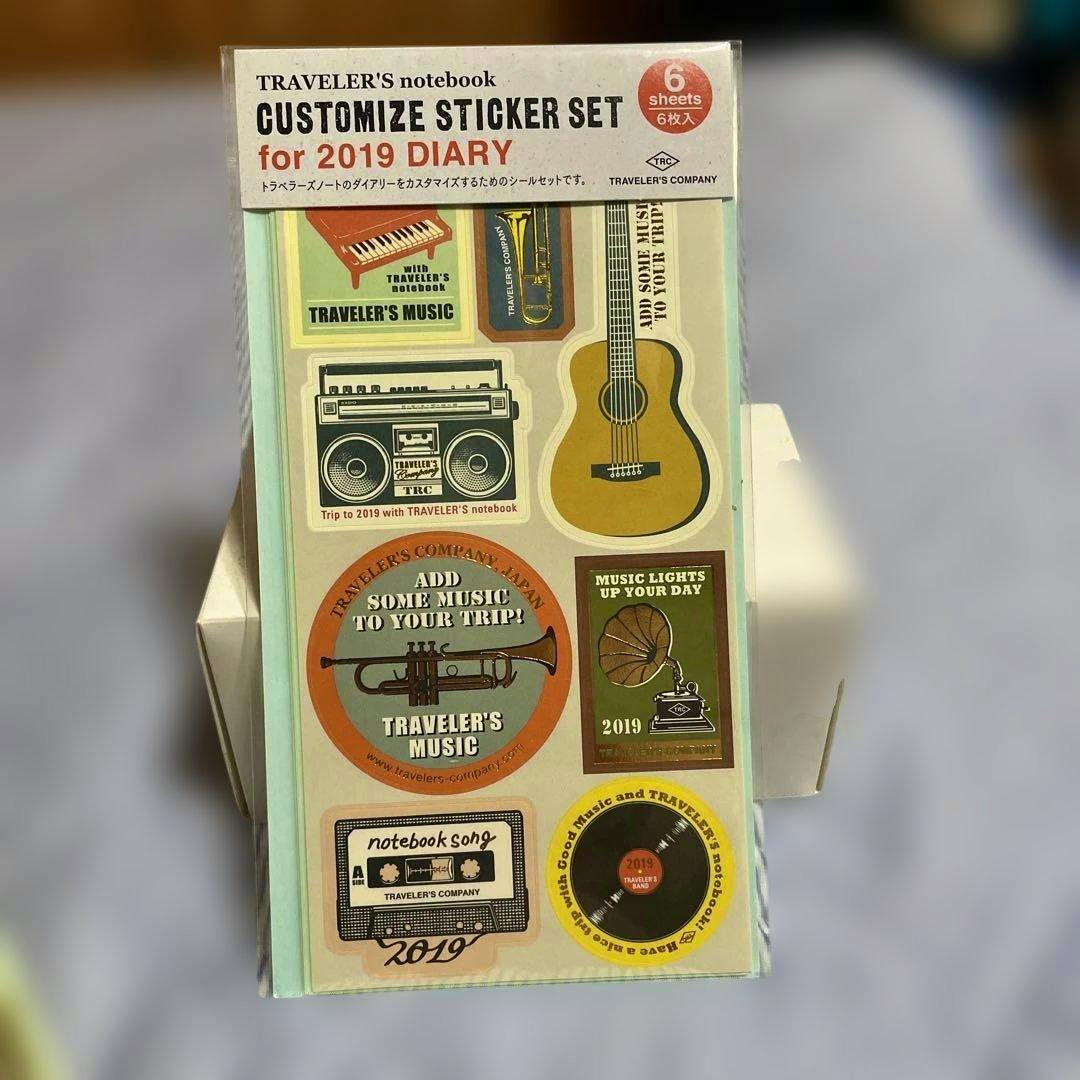 Front of packaged Traveler's Notebook customize sticker set for 2019 diary showing music-themed sticker designs.