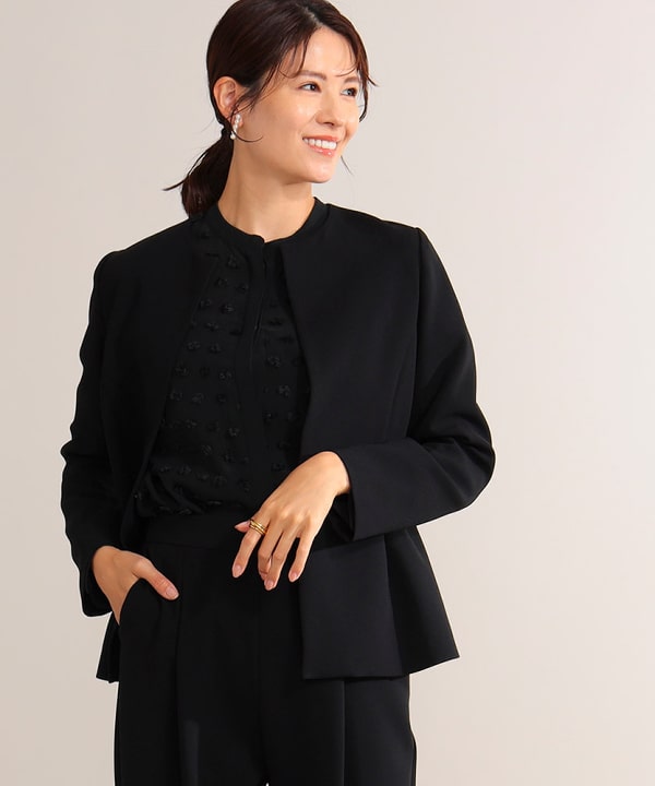 Model wearing the triacetate peplum jacket shown from the front.