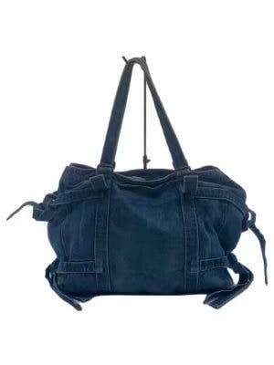 Blue cotton tricot COMME des GARCONS bag with two shoulder straps and side tie details on a white background.