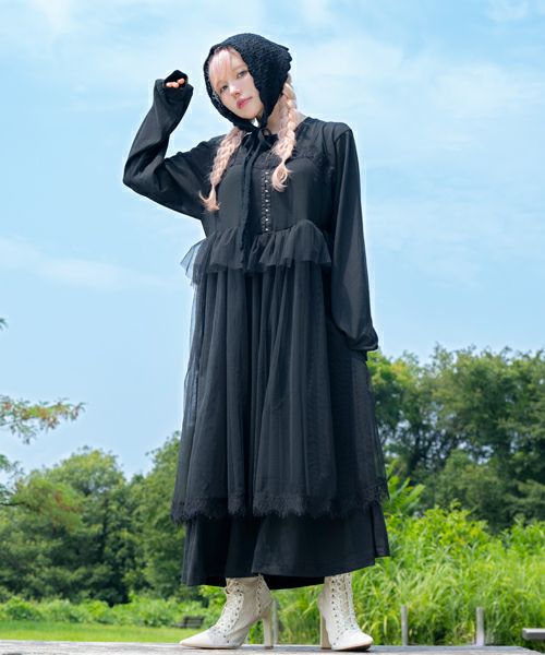 Model wearing the CELESTIAL TULLE LAYERED DRESS, a black layered tulle women's dress, standing outdoors.