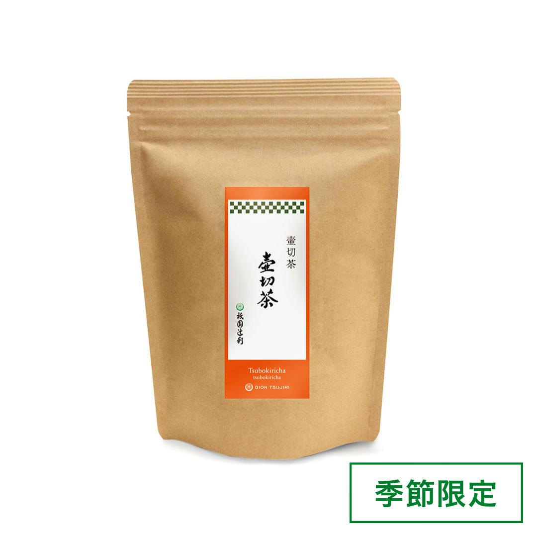 A kraft resealable pouch of loose green tea with a white and orange vertical label showing Japanese text.