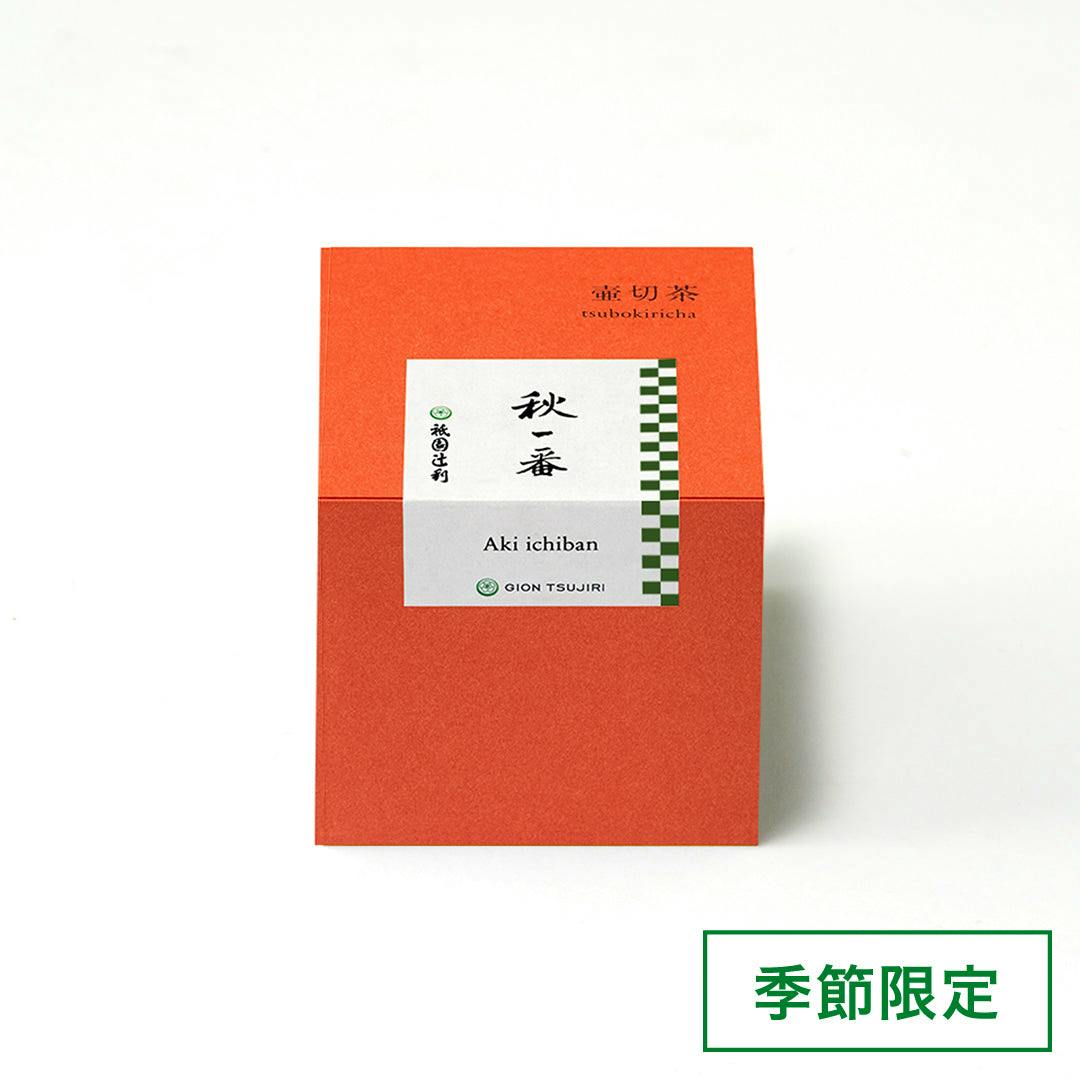 Front view of an orange box of loose leaf green tea labeled “Aki ichiban” (壷切茶) with its product label visible.