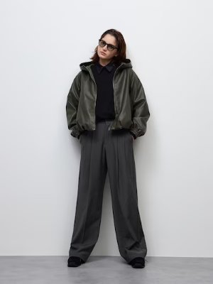 Model wearing the women's tuck wide polyester pants shown full-length.