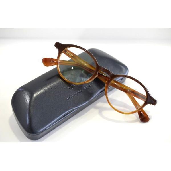 Brown TURNING T-181 eyeglass frames placed on a black hard glasses case.