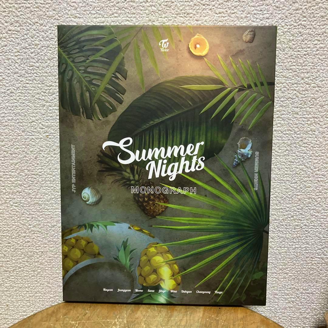 Front cover of the TWICE 写真集 MONOGRAPH "Summer Nights" photo book showing tropical leaves, pineapples, and the title text.