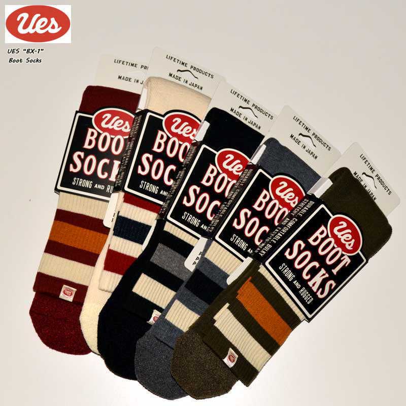 Five UES "BSX-1" boot socks in different striped colorways with their product labels attached, laid flat.