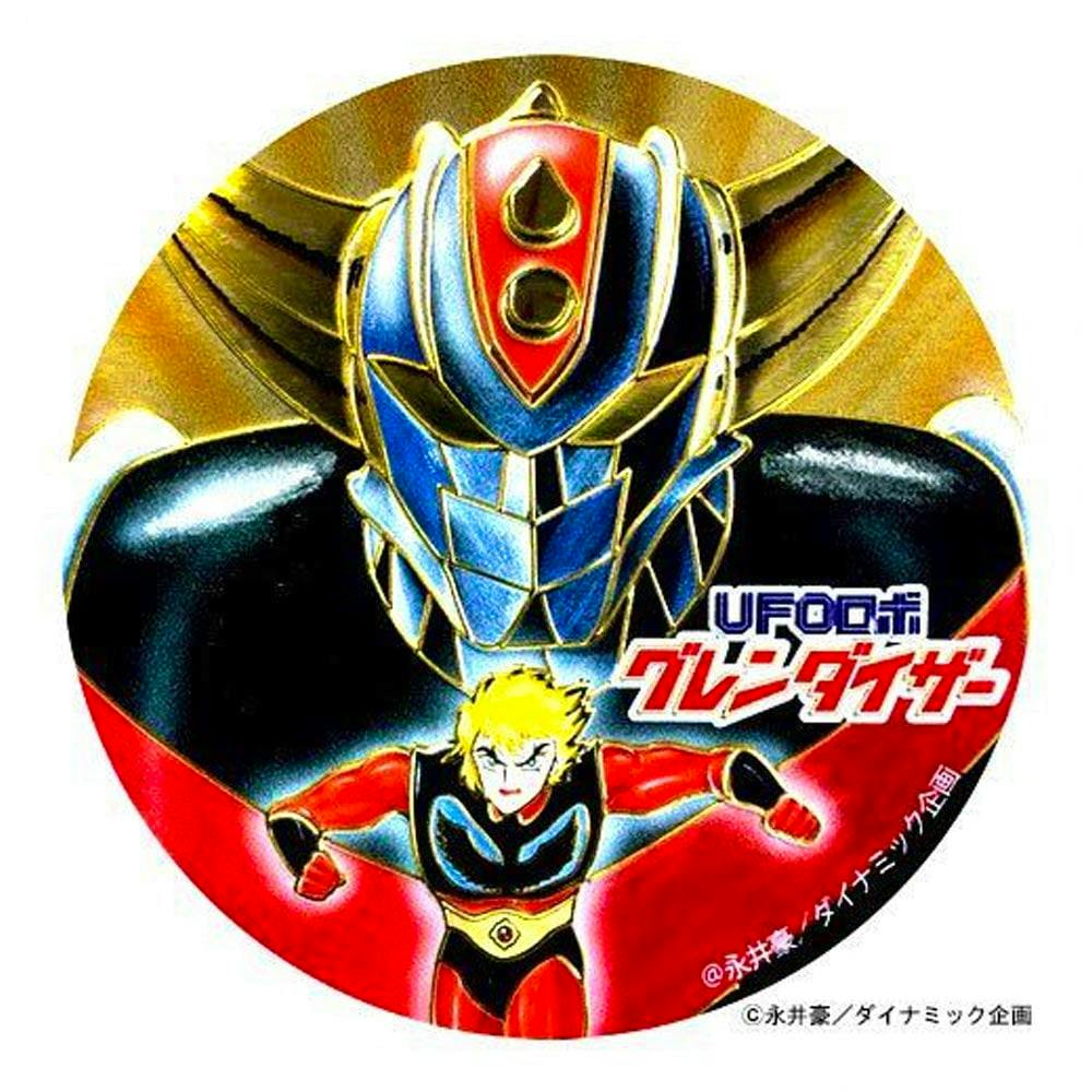 Round paper sticker showing UFO Robo Grendizer's helmeted head above the pilot Kabuto Koji with the Japanese "グレンダイザー" title.
