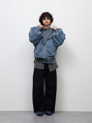 Model wearing black 3D barrel sweat pants, shown full-length.
