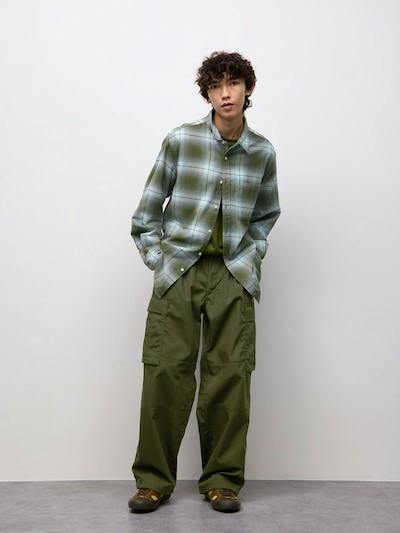 Male model wearing the Wide Cargo Pants in olive, shown full-length against a plain white background.