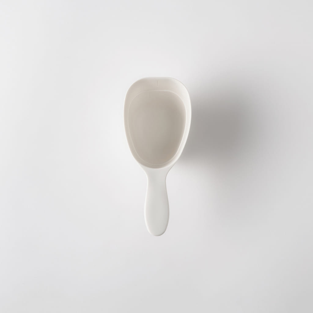 Top-down view of a white plastic rice measuring cup on a plain white background.