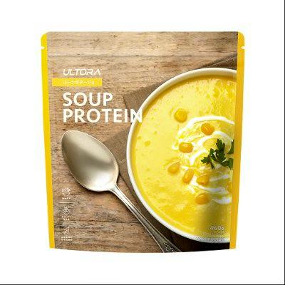 Front view of a resealable pouch labeled "SOUP PROTEIN" showing a bowl of yellow soup and a spoon.