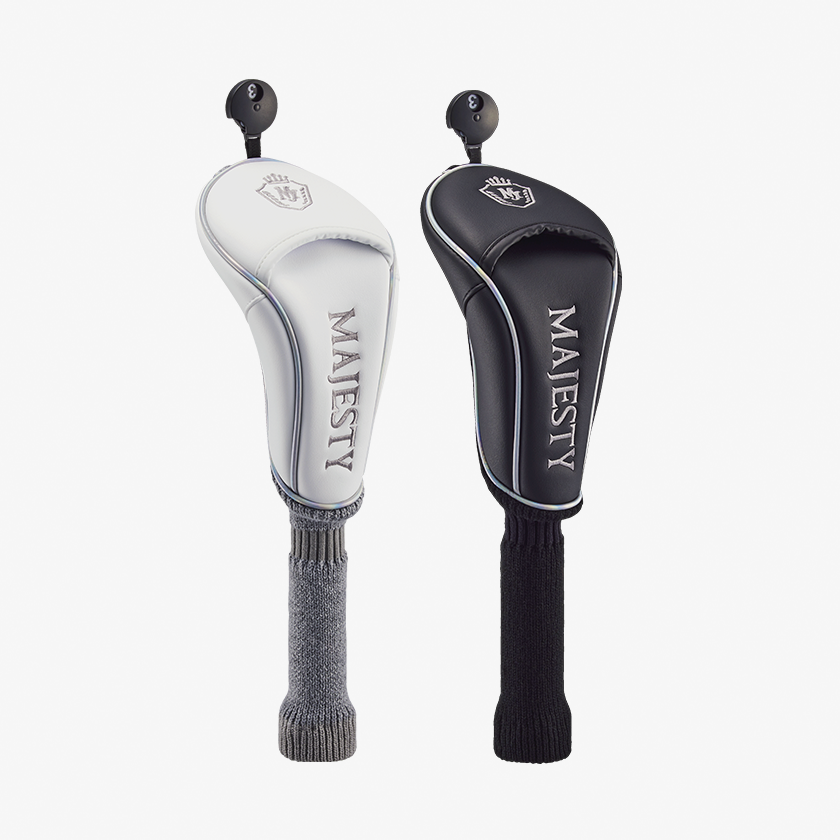 Two golf club head covers, one white and one black, displayed with knitted shaft covers on a white background.