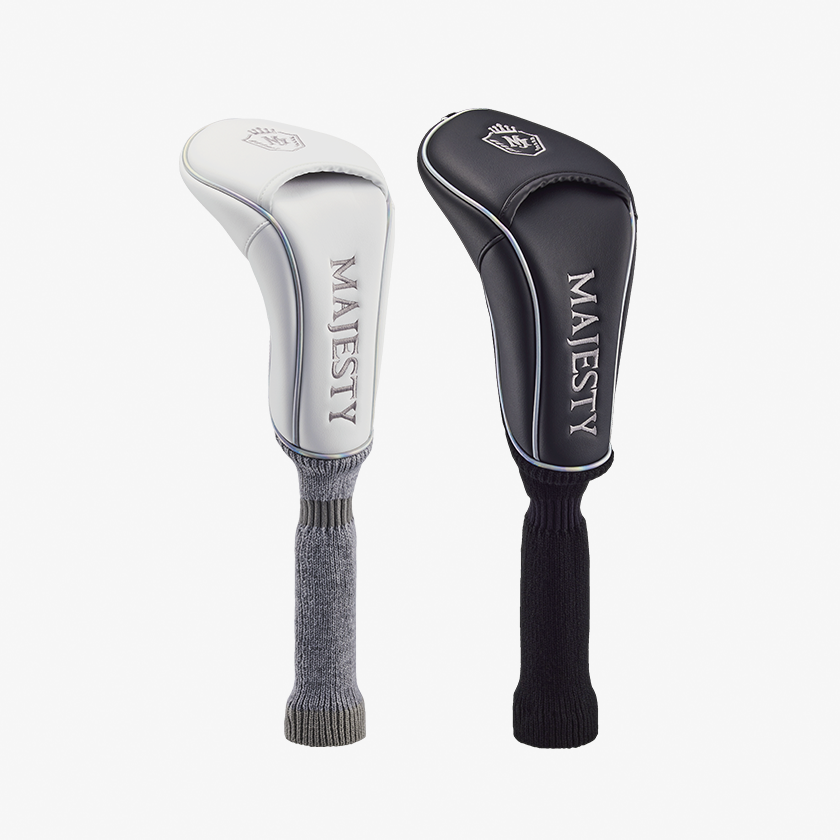 Two driver golf club head covers (wood) in white and black with MAJESTY branding visible.