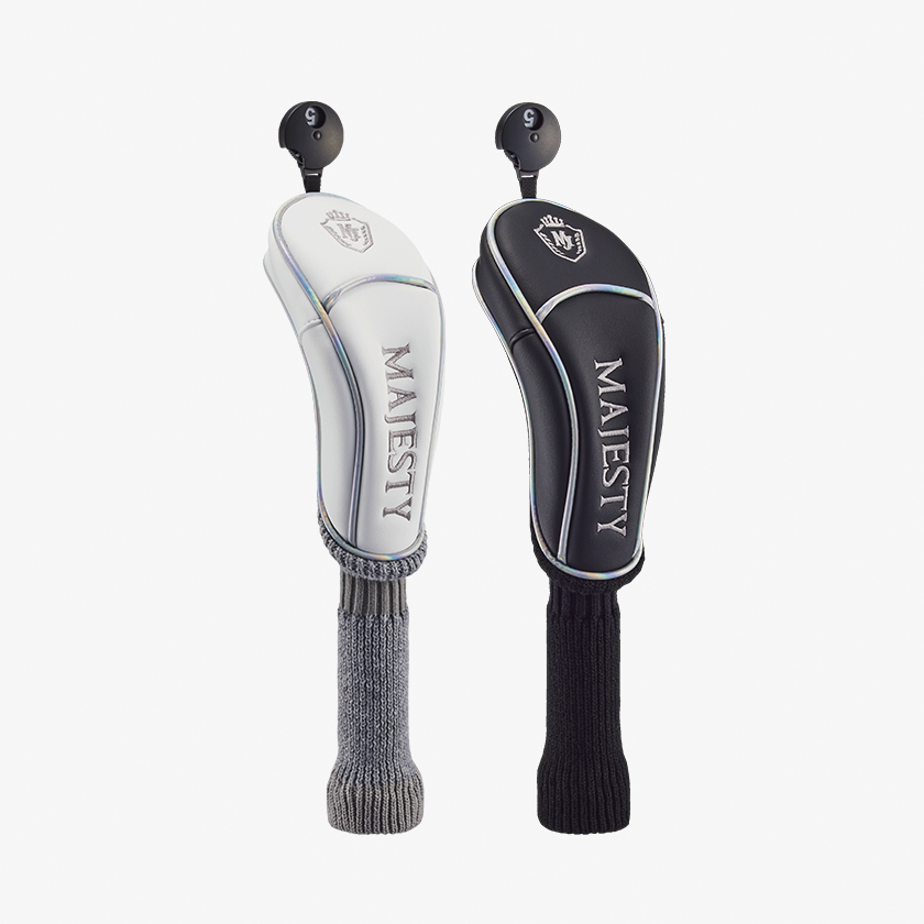 Two golf club wood head covers, one white and one black, with knit sock extensions and "MAJESTY" branding on a white background.