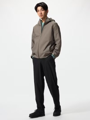 Male model wearing the men's nylon jogger pants shown full-length, hands in pockets.