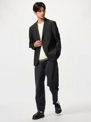 Male model wearing the men's polyester tapered pants shown full-length.