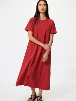 Model wearing a long red women’s dress shown full-length.