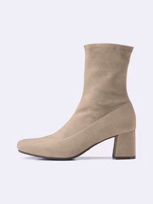 Side view of a synthetic leather stretch heel boot.