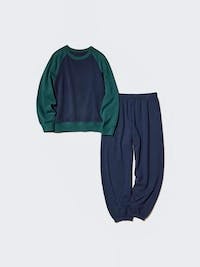 Flat-lay of a women's pyjama set showing a long-sleeve top and matching pants in navy and green.