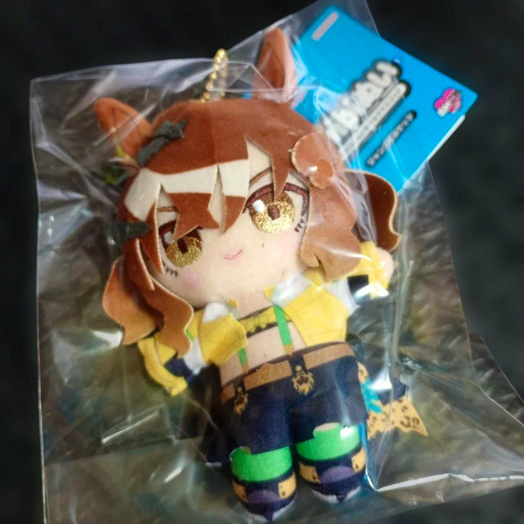 Front view of the Jungle Pocket chibi sitting plush mascot in its plastic packaging showing the embroidered face, outfit, and attached tag.
