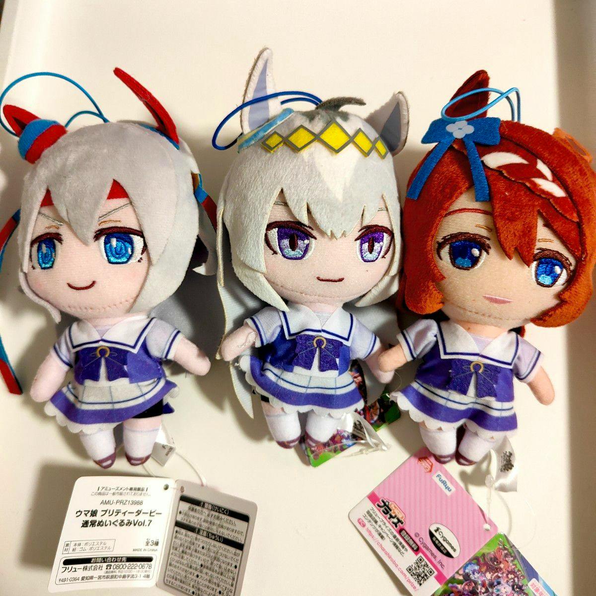 Three Umamusume Pretty Derby plush toys in school uniforms (Oguri Cap, Tamamo Cross, and Super Creek) shown from the front with tags visible.