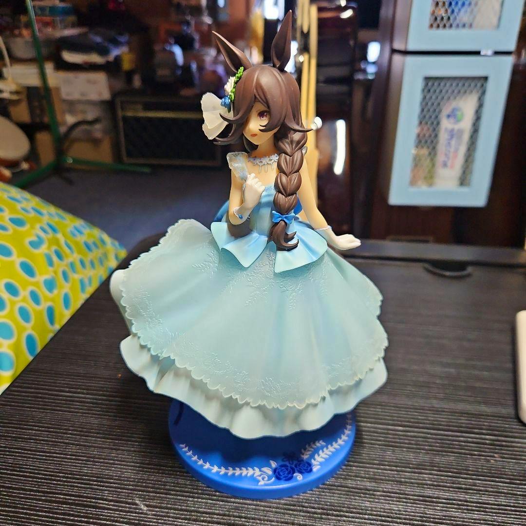 Front view of the Uma Musume “Rice Shower” figure wearing a light blue dress standing on a blue base (box not included).
