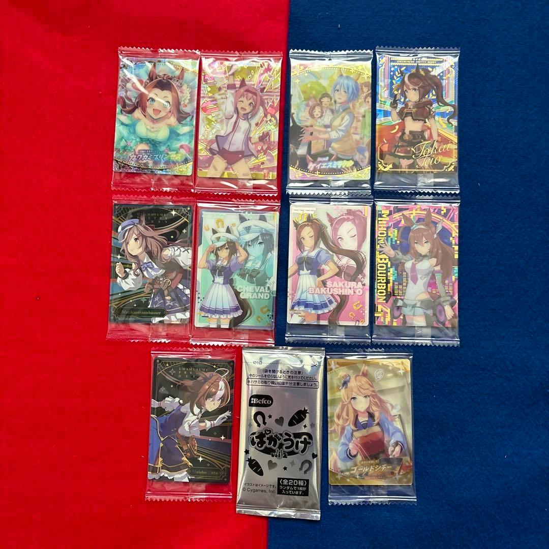 Ten sealed Uma Musume photocard packs and one sealed bonus foil pack displayed on a red and blue background.