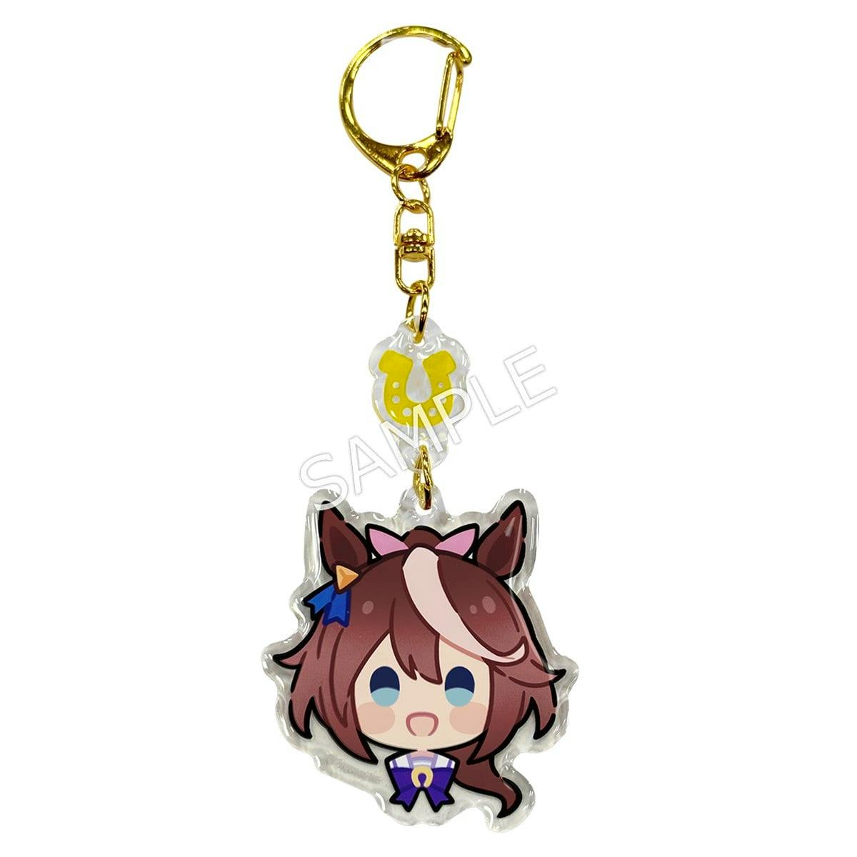 Acrylic keychain of Tokai Teio's chibi face with a gold key ring and a small yellow horseshoe charm.