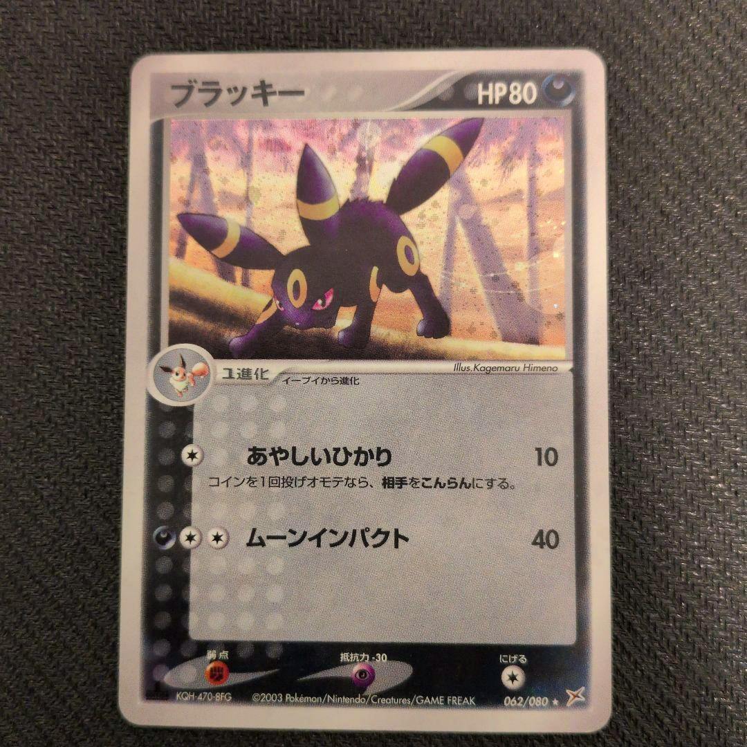 Photograph of the front of a Japanese ブラッキー (Umbreon) Pokémon trading card showing the artwork, HP, and attack text.