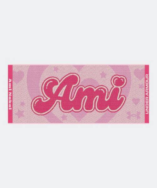 Full pink cotton face towel photographed flat, showing large "Ami" script, heart and star background pattern, and Under Armour branding on the right edge.