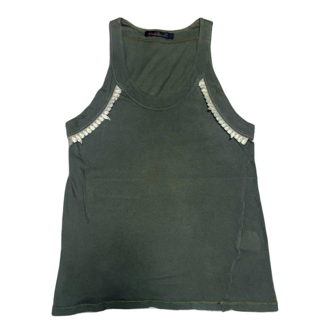 Front view of a dark green cotton tank top with decorative trim along the armholes.