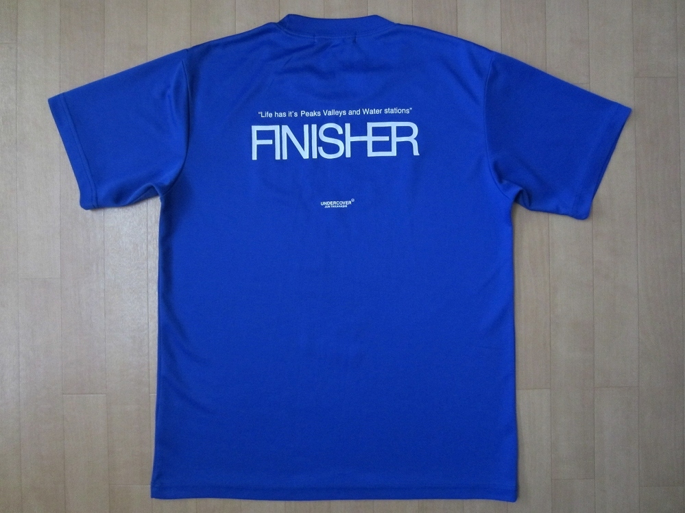 Blue polyester T-shirt (M) laid flat showing the back with large "FINISHER" text and small additional print.
