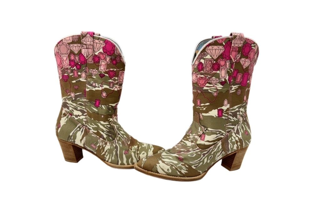 Pair of UNDERCOVER desert camo boots with pink embroidery and stacked heels.
