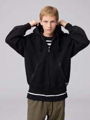 Male model wearing a black heavyweight full-zip hooded sweatshirt with front pockets.