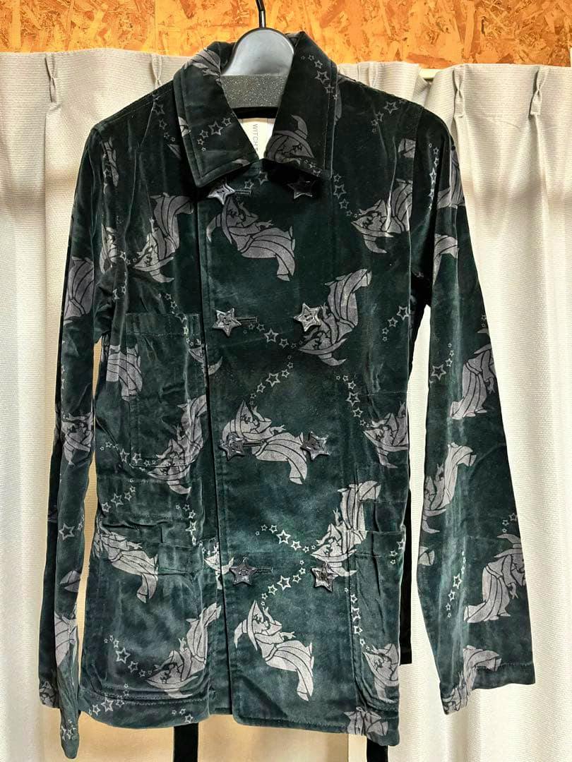 Front view of the UNDERCOVER velour men's P-coat jacket (size S) hanging on a hanger against a curtain.