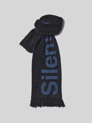 A dark polyester scarf with fringe and large blue lettering, shown partly rolled and laid flat on a light background.