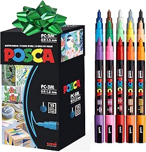 Uni-Ball uni POSCA PC-3M marker set box shown next to multiple colored PC-3M felt-tipped markers.