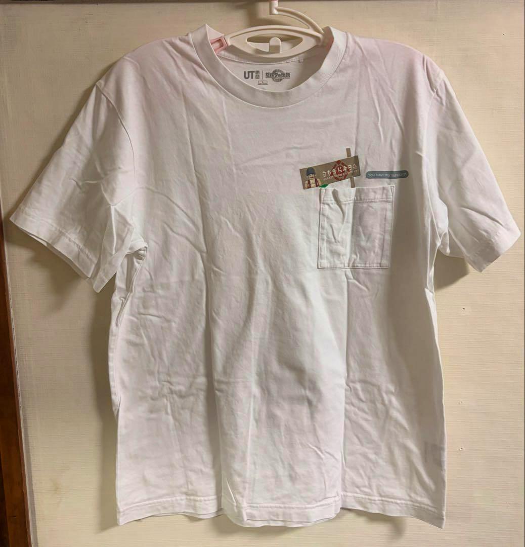Front view of the white UNIQLO UT The Legend of Zelda T-shirt (size L) hanging on a hanger, showing a chest pocket and a small printed graphic.