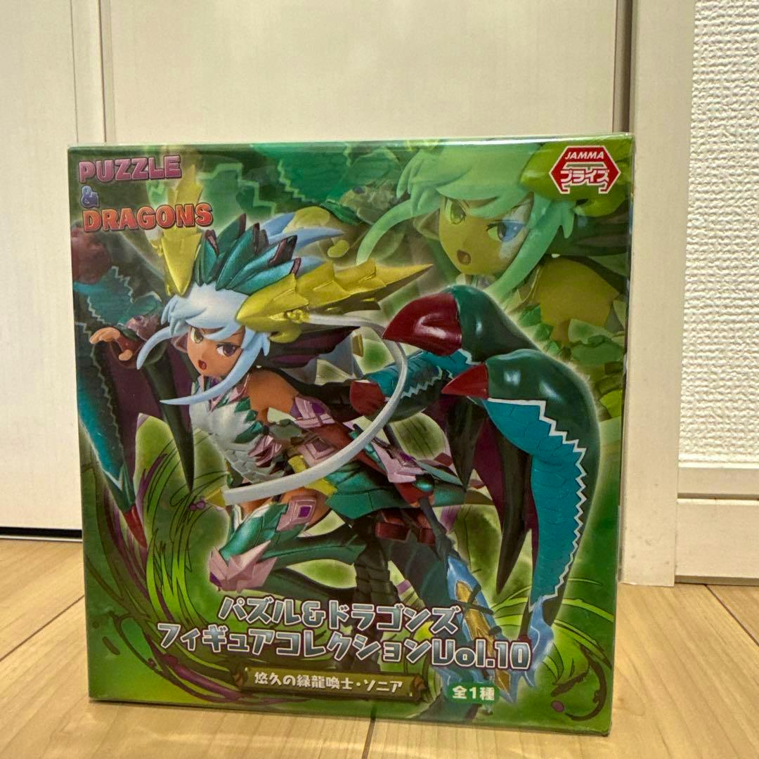 Front view of the boxed, unopened Puzzle & Dragons Figure Collection Vol.10 showing artwork of the green dragon-summoner Sonia and the product title.