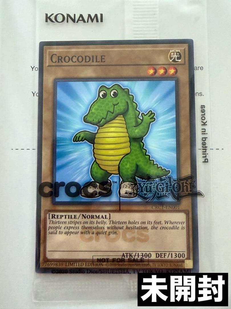 Sealed front of a Yu‑Gi‑Oh! Crocodile trading card showing the crocodile artwork with Crocs and Yu‑Gi‑Oh! logos.