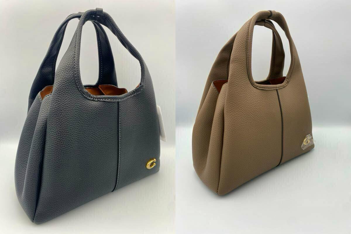 Two COACH CM545 cow leather bags, one black and one dark stone, shown side by side.