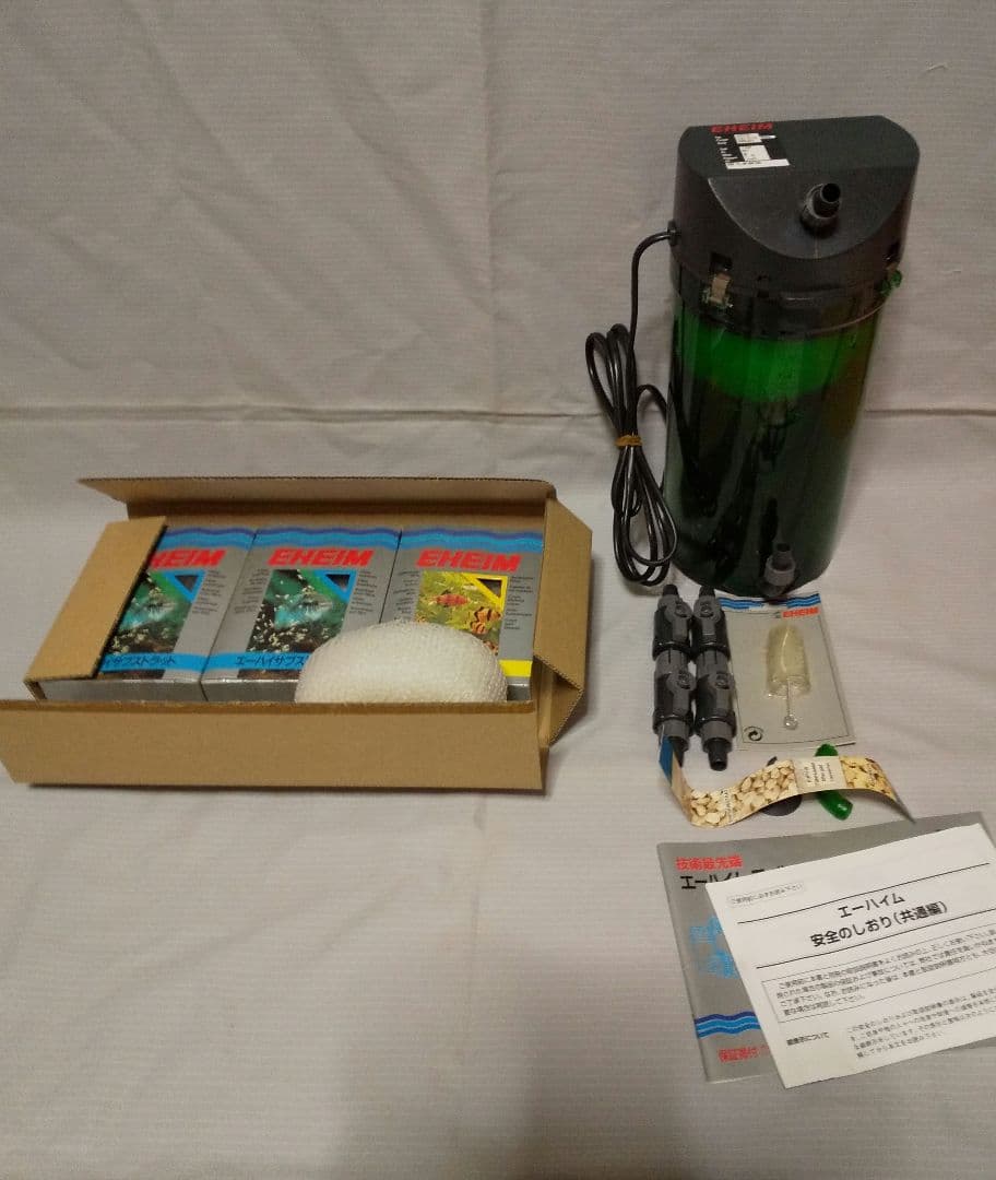 EHEIM 2213 canister aquarium filter and accessories arranged on a surface.