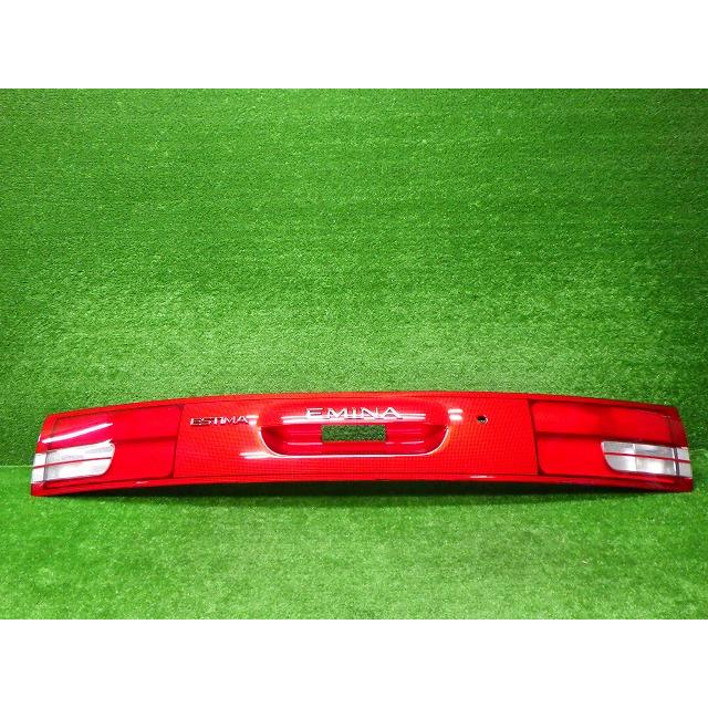 Red Toyota Estima / Emina rear garnish trim panel with central recess shown on green background.