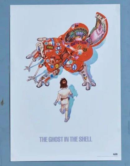 B2 poster showing a red mechanical creature above a human figure with the text "THE GHOST IN THE SHELL" at the bottom.