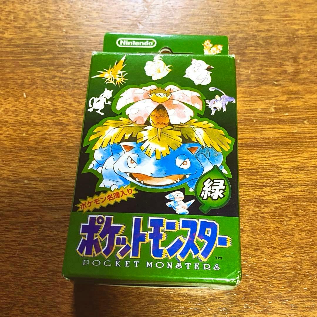 Sealed green Pocket Monsters playing card deck box featuring Venusaur artwork on a wooden surface.