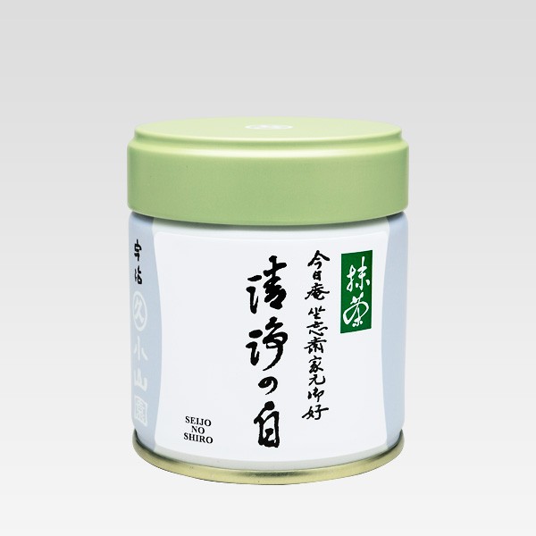 A white metal tea canister with a pale green lid and Japanese label for the matcha green tea 裏千家御好 清浄の白.